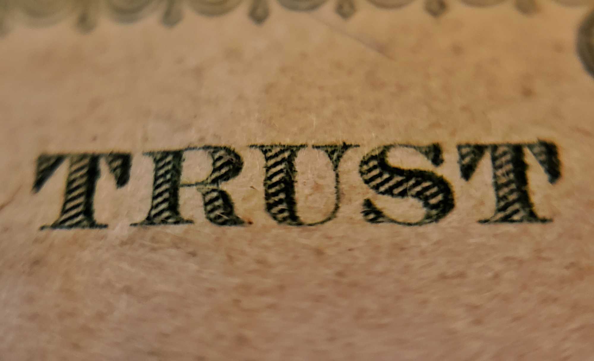 "Trust" close up on a dollar bill